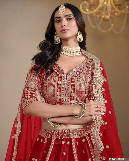 Woman in a red and gold traditional outfit with jewelry against a beige background