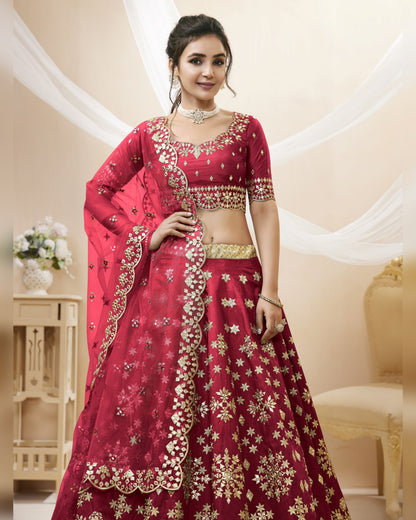 Woman wearing a red and gold embroidered traditional outfit in an elegant indoor setting.