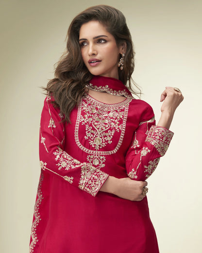 Woman wearing a red embroidered traditional outfit on a beige background