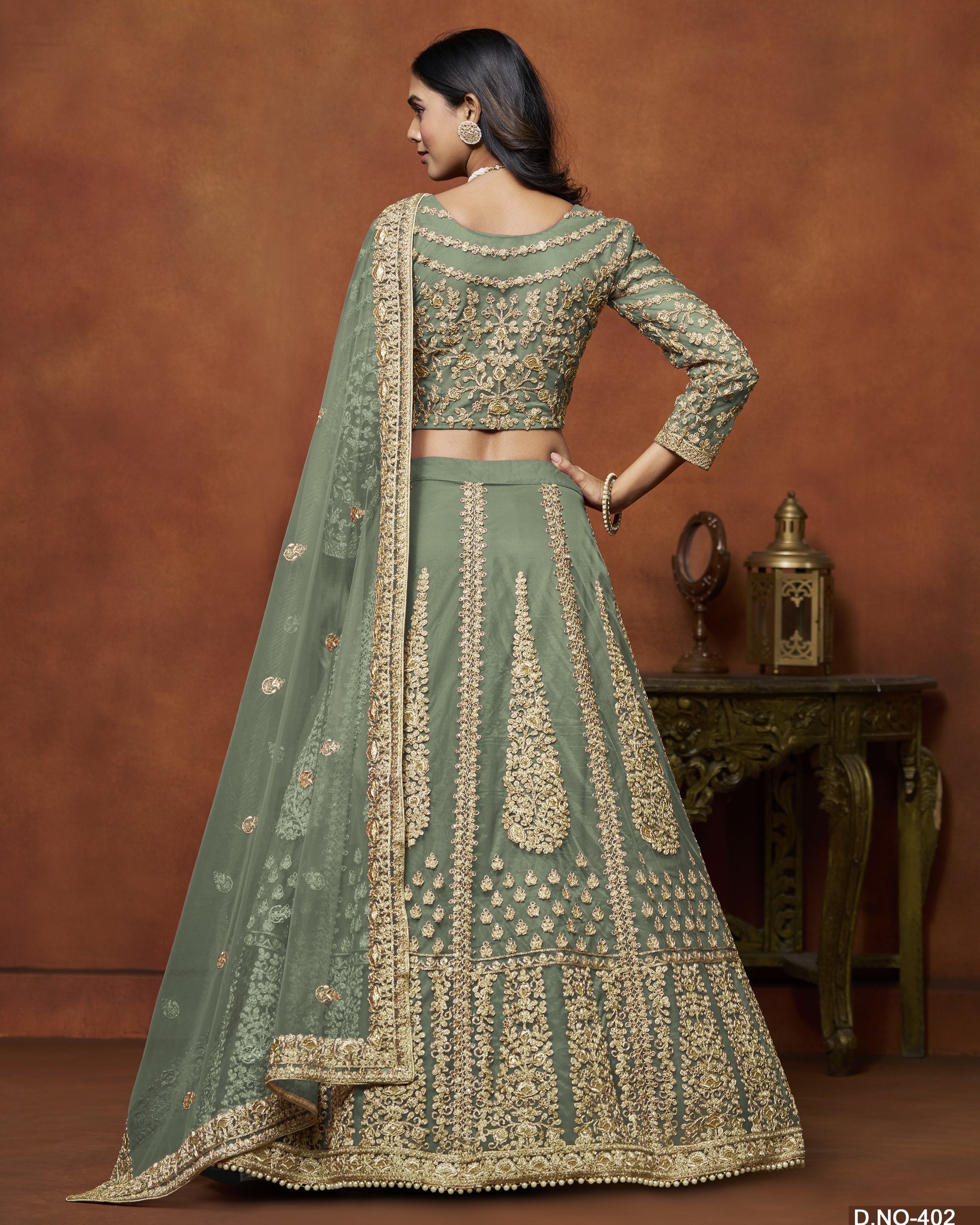 Woman wearing a green embroidered traditional outfit with a brown background