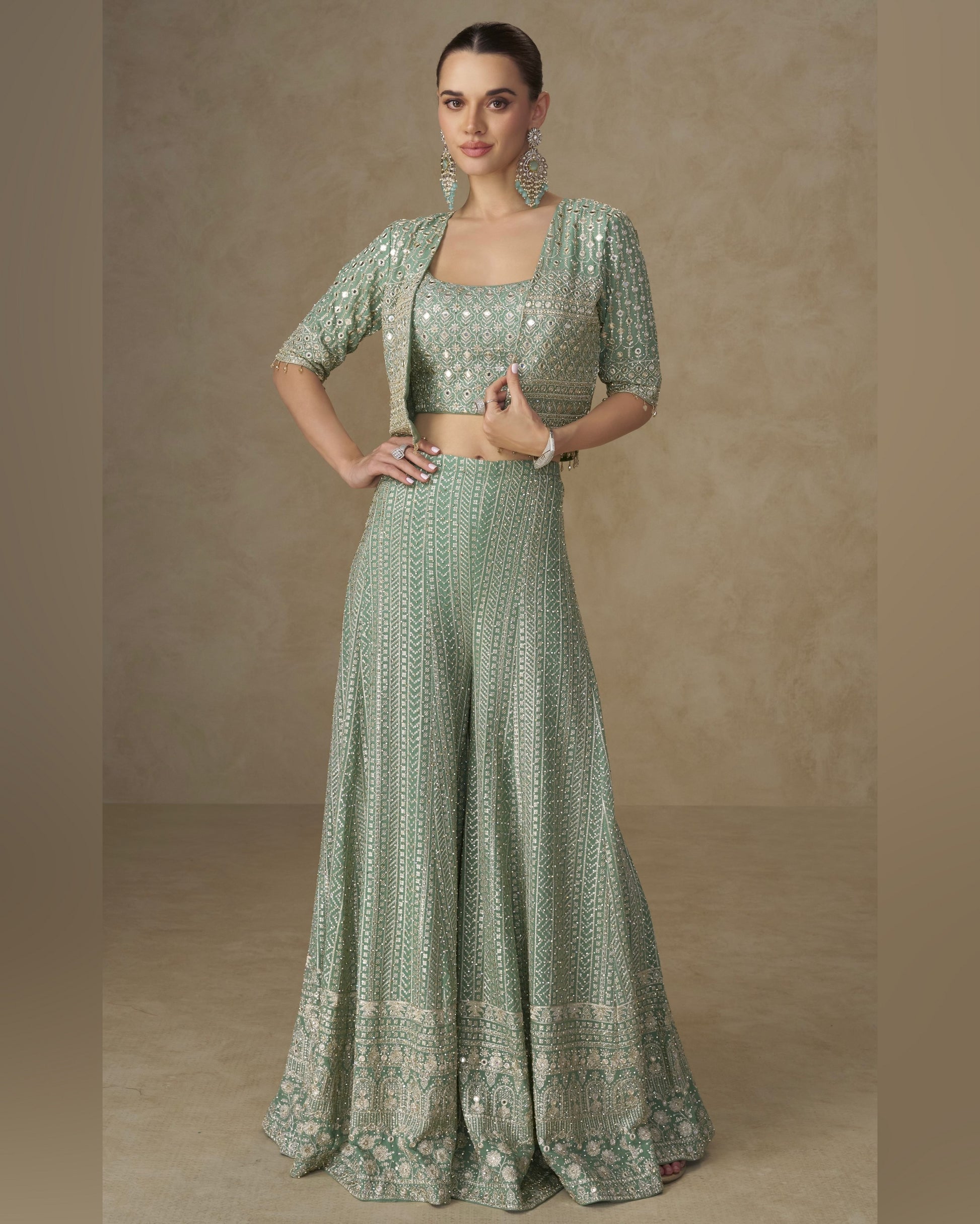 Woman wearing a green traditional outfit with a plain background