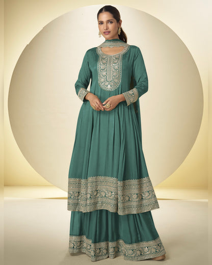 Teal traditional outfit with intricate patterns on a neutral background
