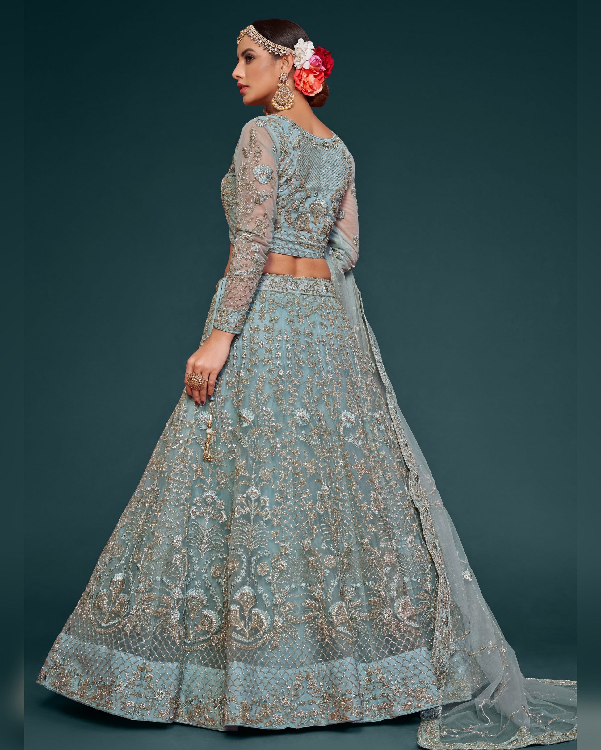 Woman wearing a traditional embroidered outfit with a dark background