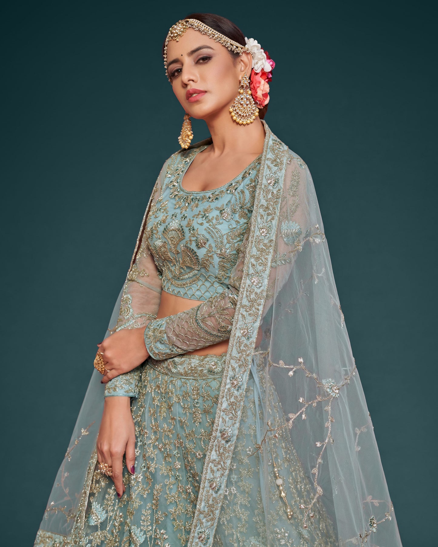 Woman in traditional embroidered outfit with jewelry against a dark background