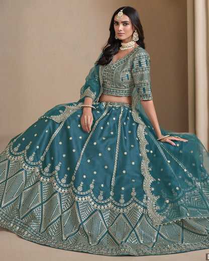 Woman wearing a teal embroidered traditional outfit with a beige background