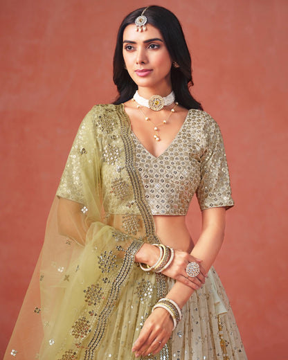 Woman in traditional embroidered outfit with jewelry against a pink background