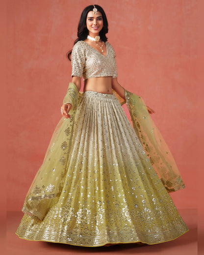Woman wearing a traditional outfit with a gold and silver lehenga on a pink background