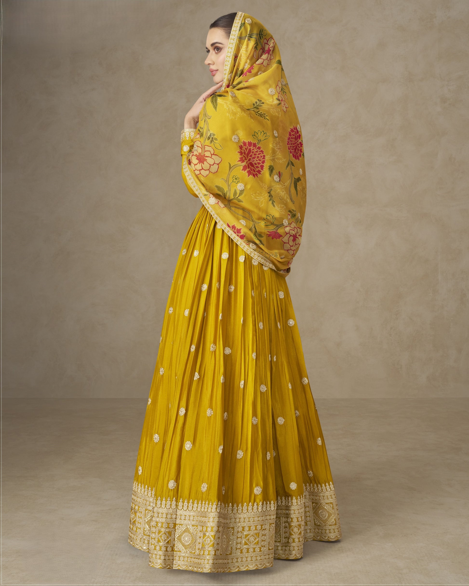 Yellow saree with floral patterns on a plain background