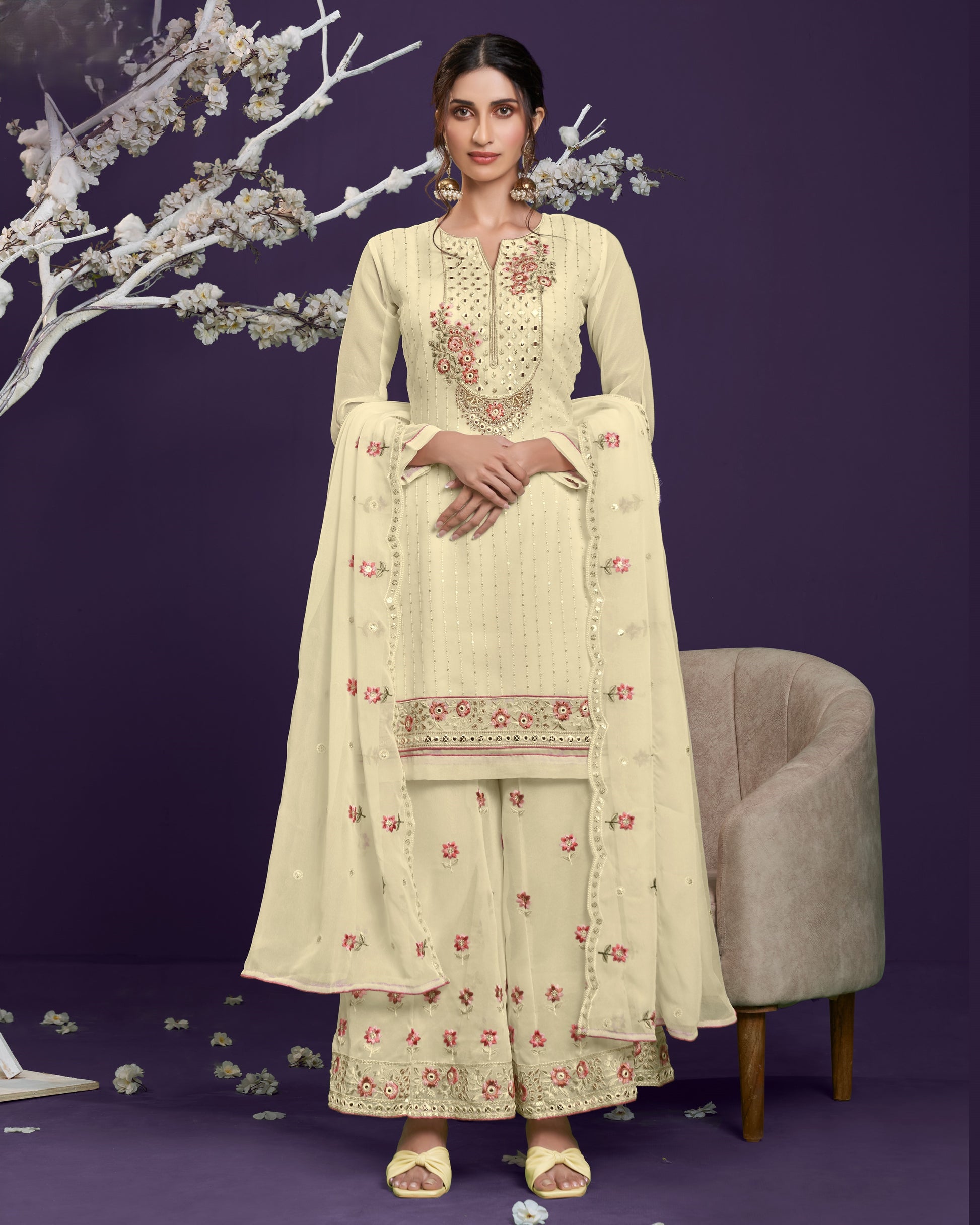 Woman in a cream embroidered traditional outfit with a purple background