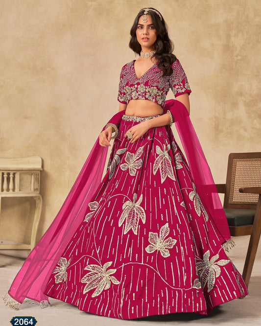 Woman wearing a pink and white floral embroidered lehenga with blouse and dupatta.