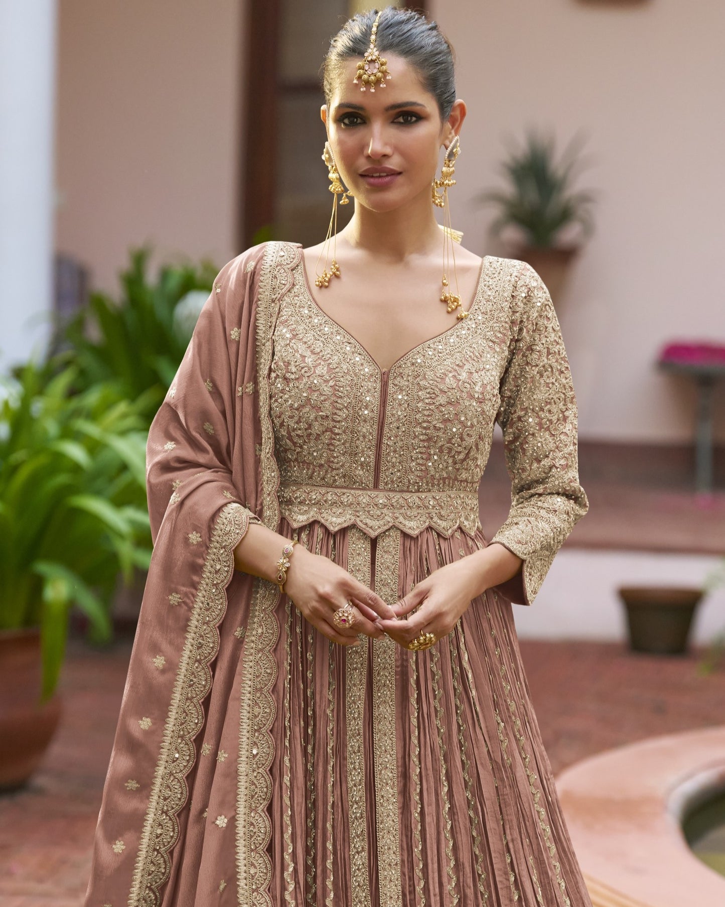 Woman in traditional embroidered dress with jewelry outdoors