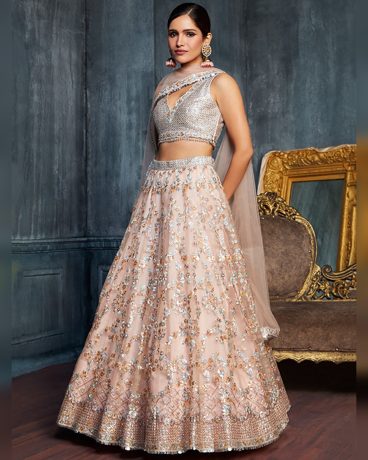 Woman wearing a traditional outfit with sequin details in a decorative setting