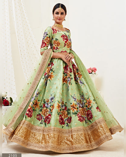 Woman wearing a light green floral dress with a matching dupatta on a white background
