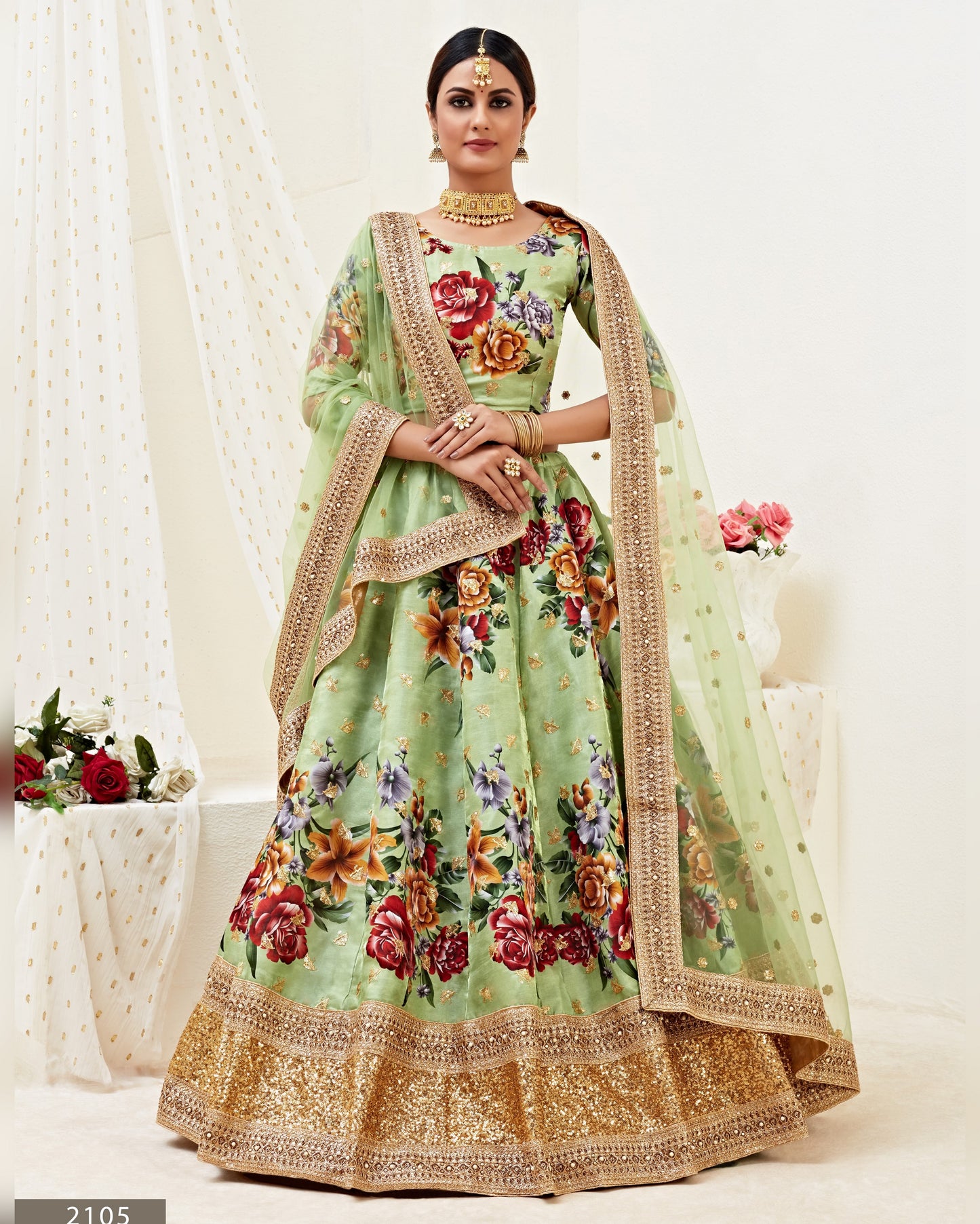 Light green traditional outfit with floral patterns on a white background