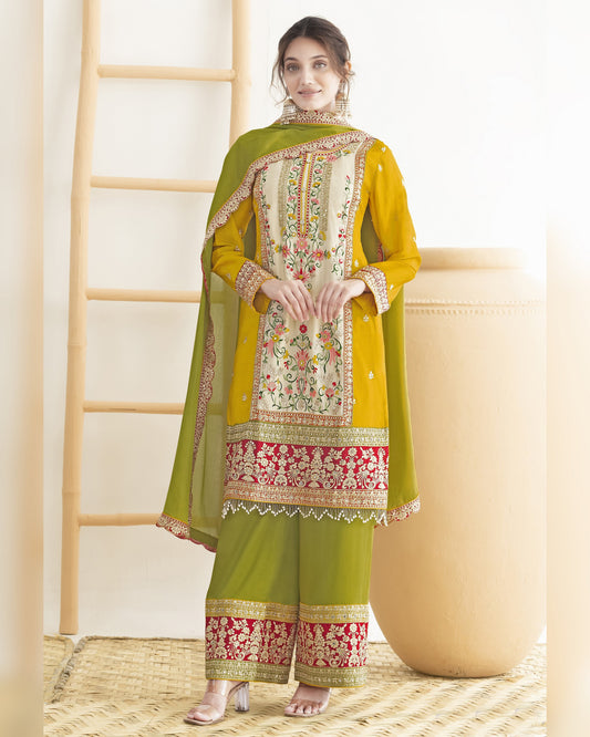 Woman wearing a green embroidered traditional outfit with a white background