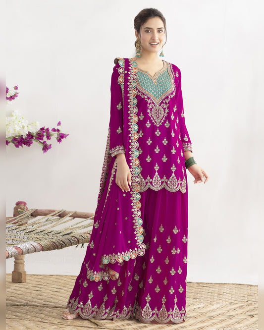 Woman wearing a purple embroidered traditional outfit with a white background