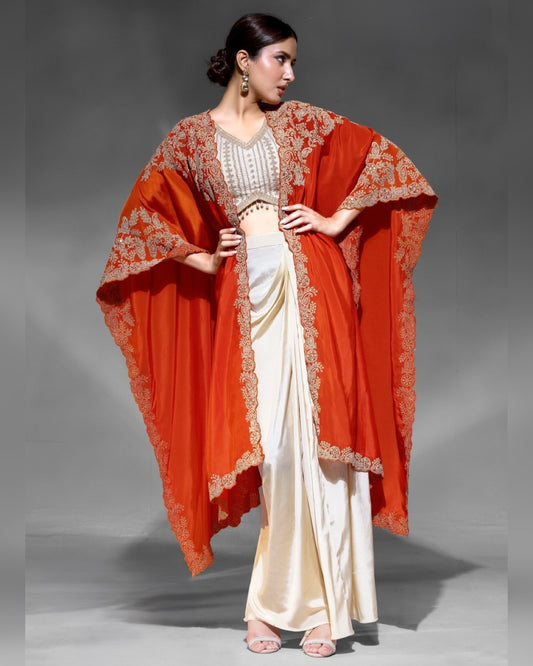 Woman wearing a red embroidered dupatta over a white saree on a gray background