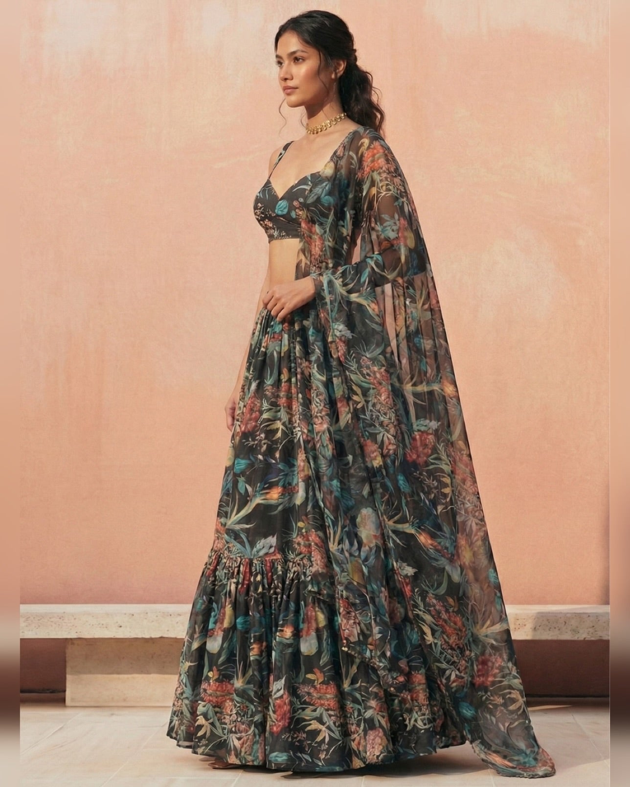 Woman wearing a floral dress against a pink wall