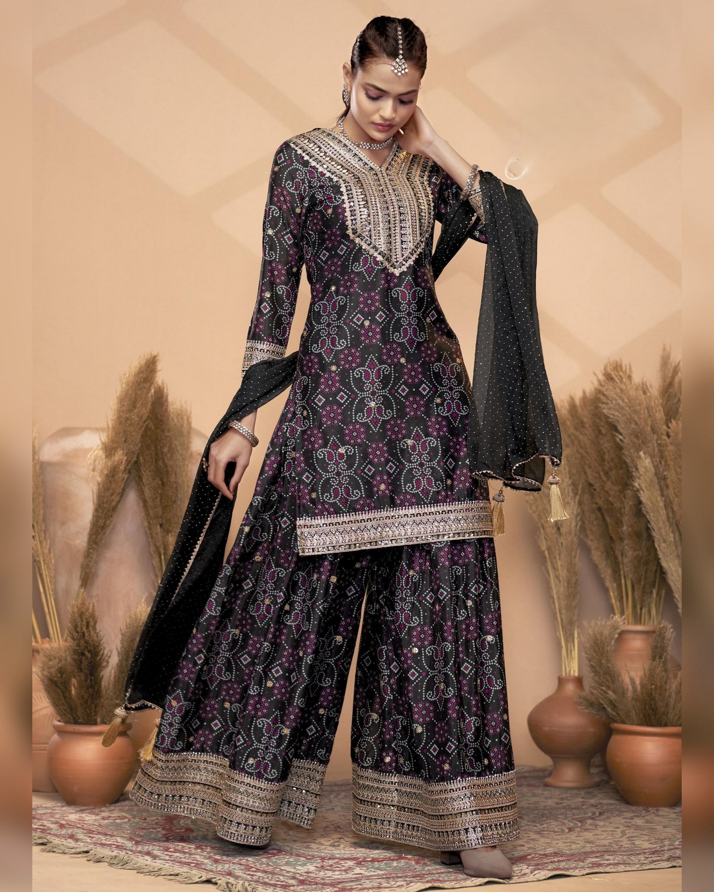 Woman wearing a black and purple patterned traditional outfit with a beige background