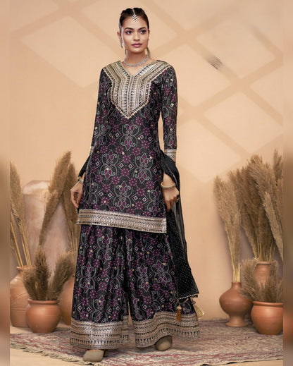 Woman wearing a traditional black and purple embroidered outfit with a beige background