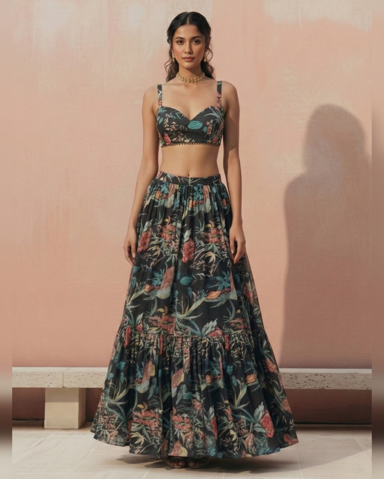 Woman wearing a floral two-piece outfit against a pink background