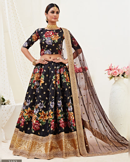 Woman wearing a floral black lehenga with a sheer dupatta on a white background